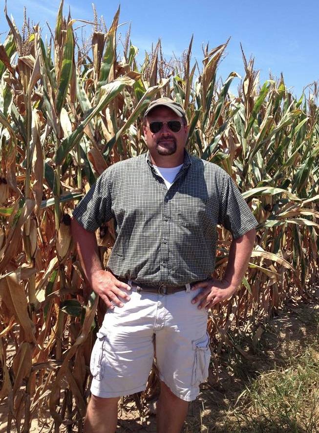 Edward Alan Epps standing in front of his corn crop